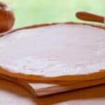 unbaked low sodium pizza crust on a cutting board