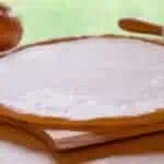 unbaked low sodium pizza crust on a cutting board