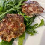 Picture of low sodium sausage patties over greens