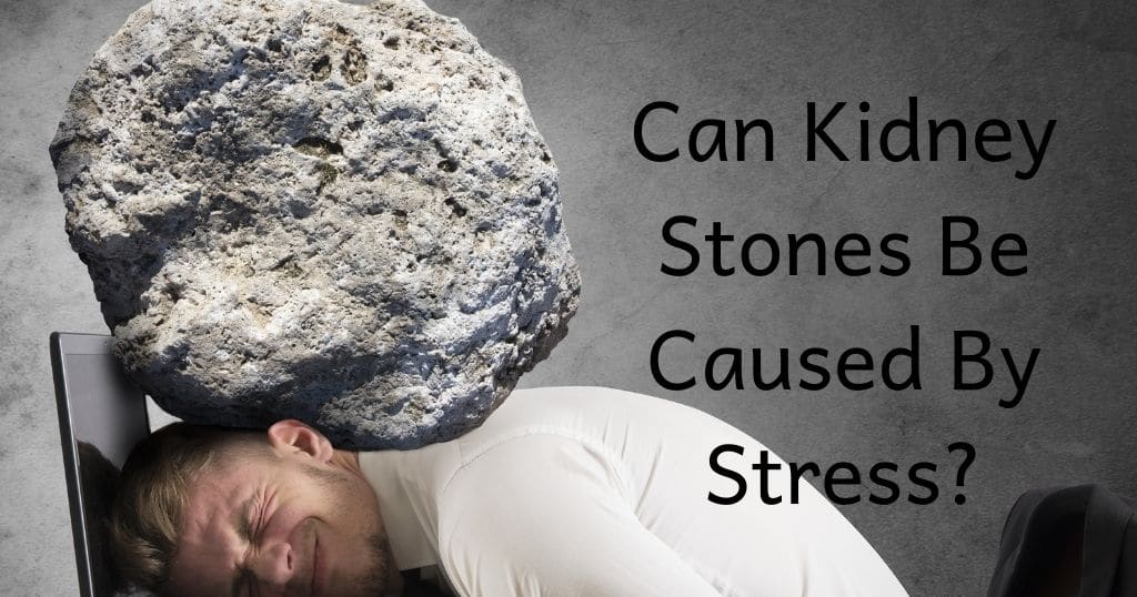 Man with head down on computer with large rock over his head.