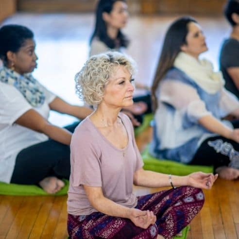Women practicing meditation together. Meditation can be a wonderful stress reduction technique