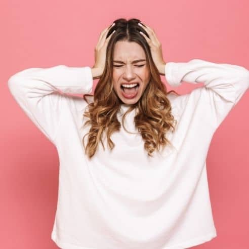 woman with hands on her head, clearly very stressed