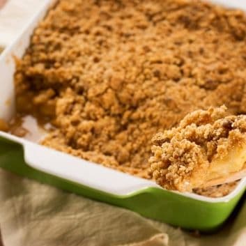 Fresh apple crumble in a green baking dish