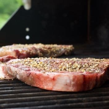 Steak on grill covered in no salt steak seasoning