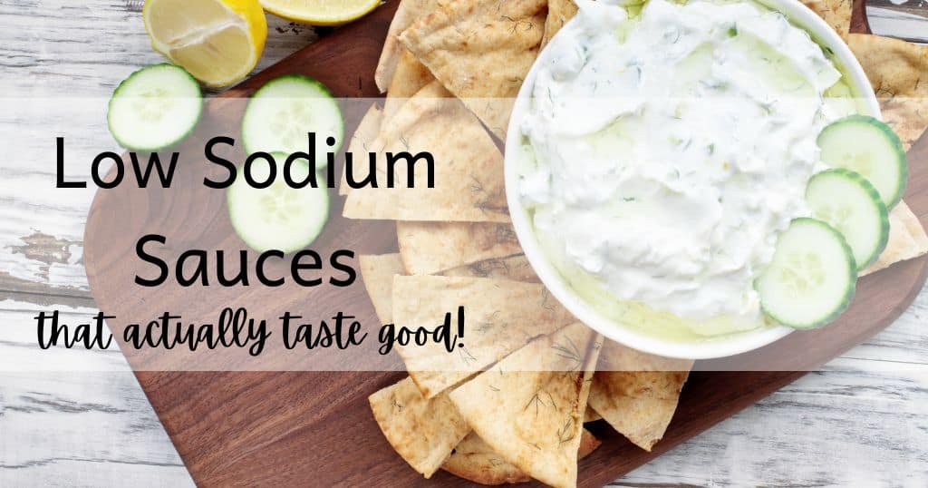 Image of tzatziki sauce on cutting board with pita chips, cucumbers and lemon with blog title: Low Sodium Sauces that actually taste good over image