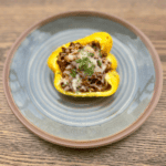 Low sodium stuffed pepper half on a blue plate