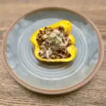 Low sodium stuffed pepper half on a blue plate