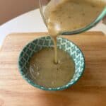 low sodium gravy being poured into a blue bowl